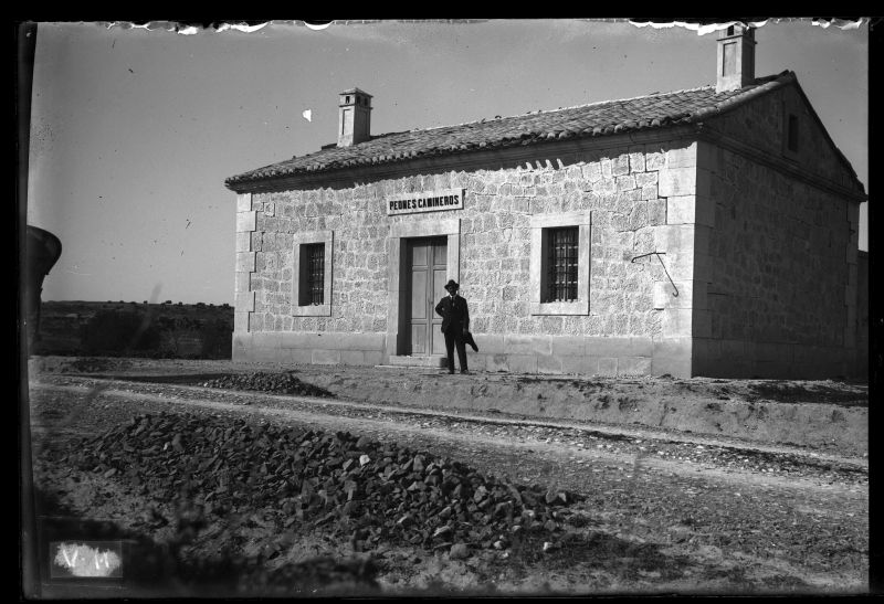 Casilla de peones camineros en Orihuela, 1915, con una figura delante del edificio
